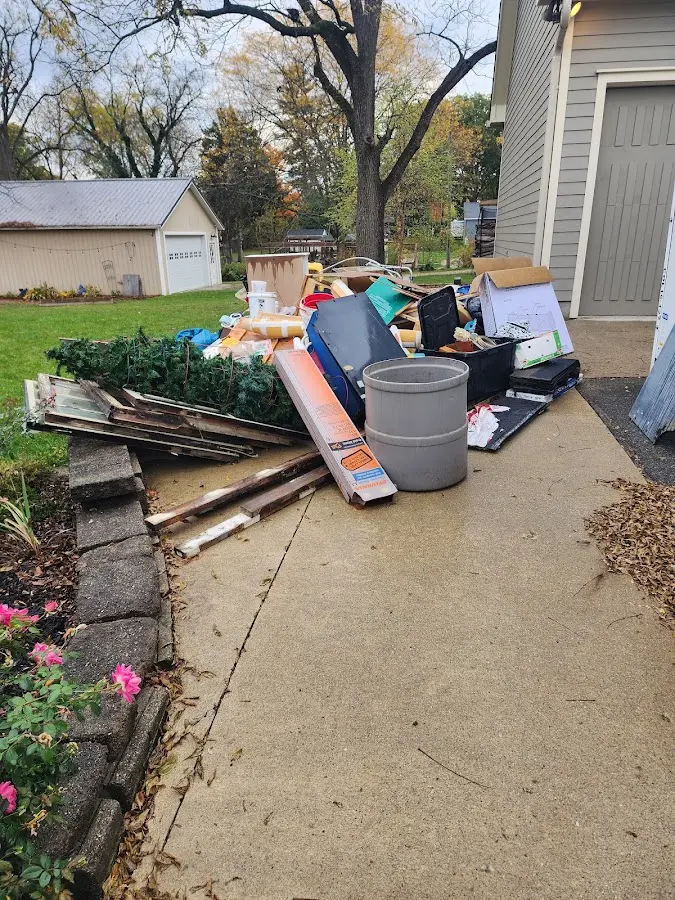 Dumpster being loaded with debris for Estate Cleanout Dumpster Rental in Portage